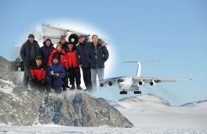 A group of people in winter clothing pose on snowy rocks in Antarctica. Above them is a faded image of the same group standing together, with a large aircraft from Antarctic Logistics and Expeditions flying low over the snowy landscape.