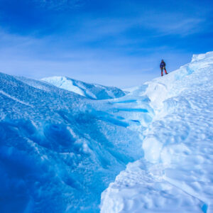 A man stands atop the ice at Drake Icefall.