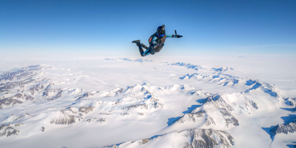 A skydiver free falls over Union Glacier
