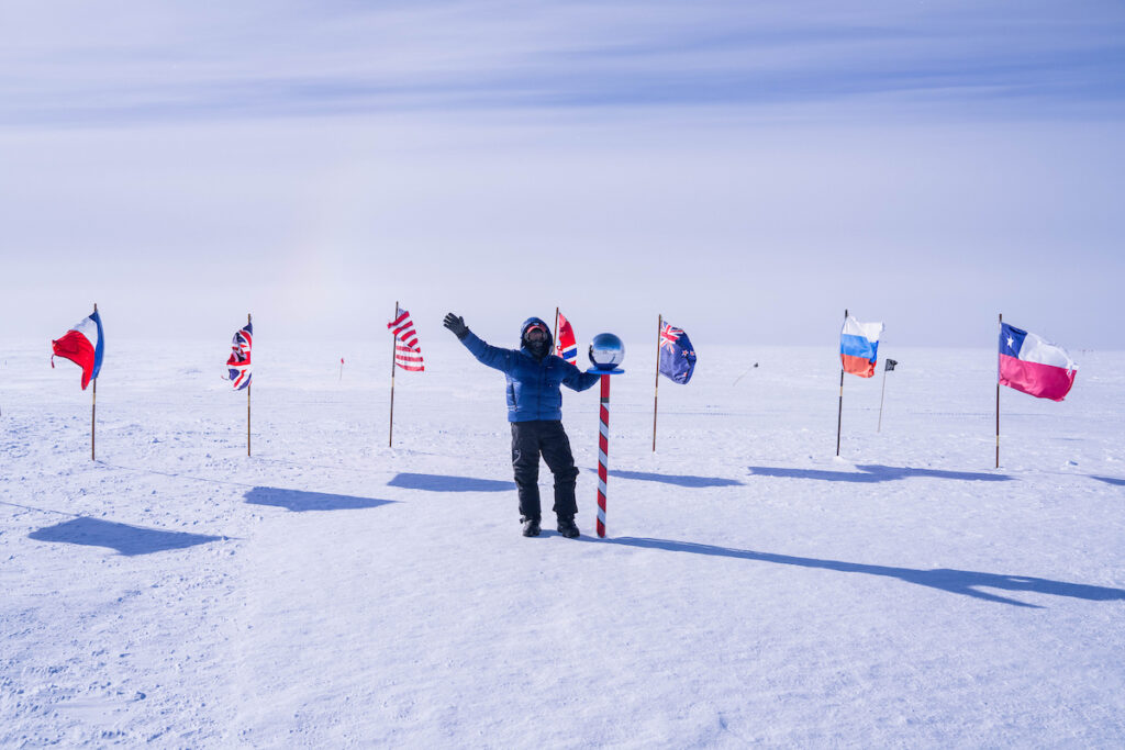 Guest George Crain poses at ceremonial South Pole.