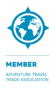 A blue and white logo featuring a globe inside a compass rose, with the text MEMBER and ADVENTURE TRAVEL TRADE ASSOCIATION below it, represents organizations like Antarctic Logistics and Expeditions connecting you to Antarctica adventures.