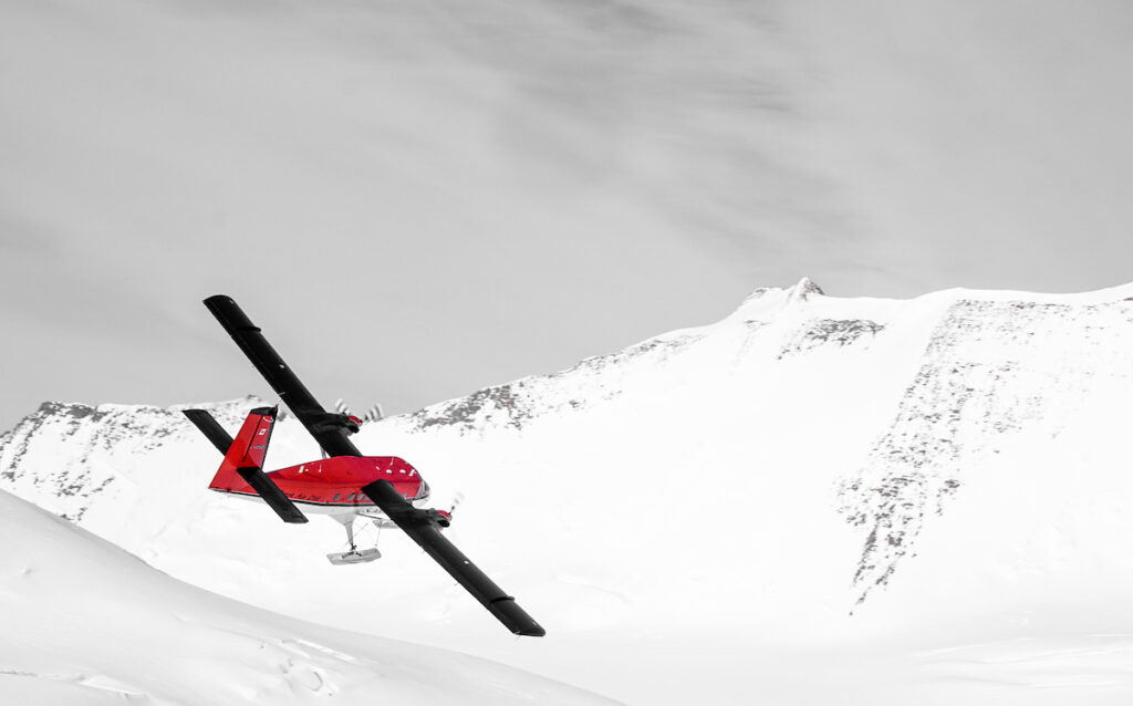 Twin Otter flying above Three Glaciers Retreat