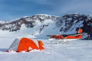 A tent with a twin otter in the background at Mount Sidley