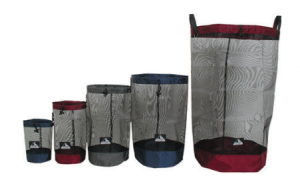 Five mesh laundry bags of varying sizes, each with a solid-colored base and top edge in red, gray, or blue—ideal for Antarctic Logistics and Expeditions or organizing essentials at the South Pole—stand upright in a row from smallest to largest.