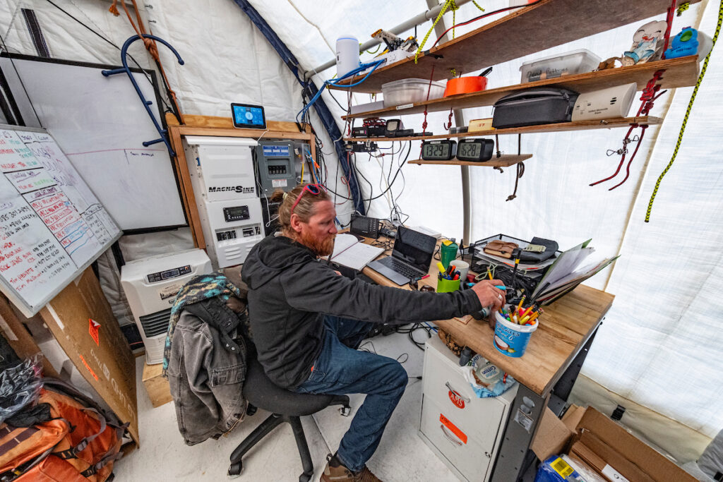 Vinson base camp manager Larry Holmgren in his office/radio room, ALE / Ken Borek Twin Otter flight Union Glacier to Vinson base camp,